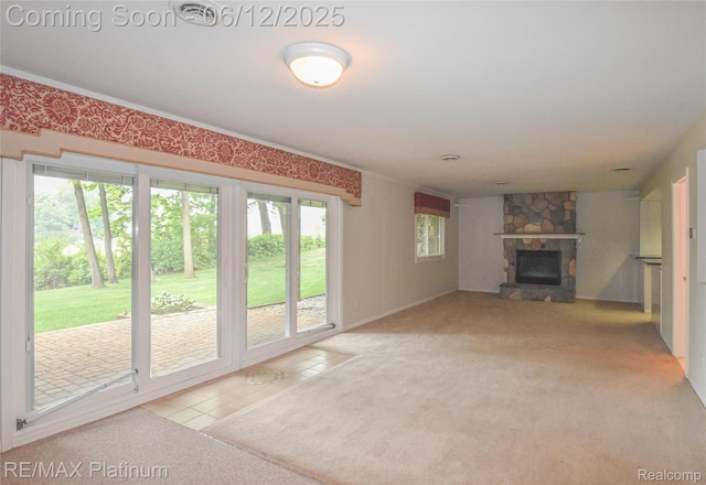 8342 Islandview Ct, Brighton, MI 48114 - unfurnished living room featuring a stone fireplace, carpet, tile patterned floors, and ornamental molding
