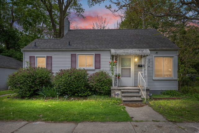 21 Woolworth, Mount Clemens, MI 48043 - cape cod house with a chimney, roof with shingles, and a yard