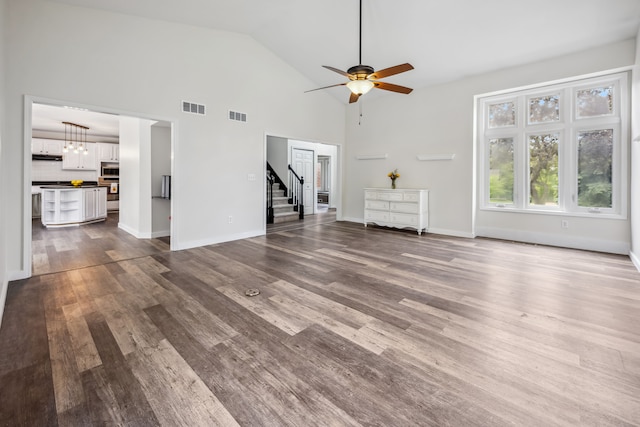 8148 Orchardview Dr, Washington, MI 48095 - unfurnished living room with dark wood-type flooring, stairs, a ceiling fan, baseboards, and high vaulted ceiling
