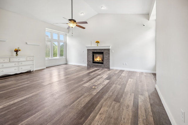 8148 Orchardview Dr, Washington, MI 48095 - unfurnished living room with a ceiling fan, wood finished floors, a brick fireplace, lofted ceiling, and baseboards