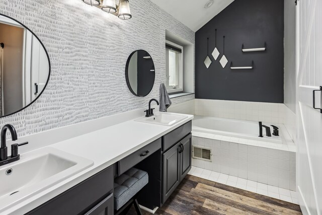 8148 Orchardview Dr, Washington, MI 48095 - full bathroom featuring wood finished floors, a relaxing tiled tub, and double vanity