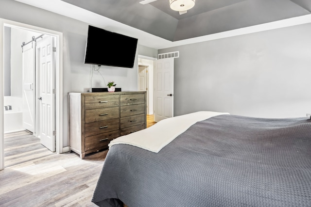 8148 Orchardview Dr, Washington, MI 48095 - bedroom with light wood-type flooring and a tray ceiling