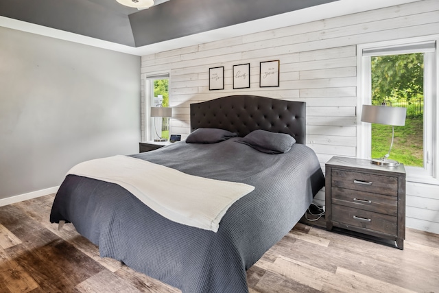 8148 Orchardview Dr, Washington, MI 48095 - bedroom with wooden walls, wood finished floors, and baseboards
