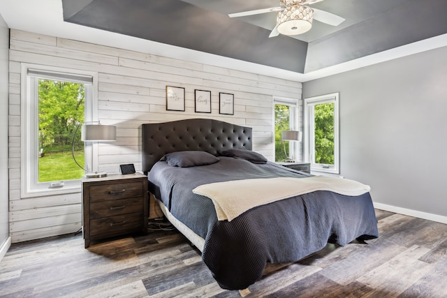 8148 Orchardview Dr, Washington, MI 48095 - bedroom with a raised ceiling, baseboards, wooden walls, wood finished floors, and ceiling fan