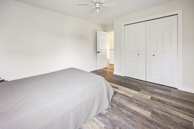 8148 Orchardview Dr, Washington, MI 48095 - bedroom featuring dark wood-style flooring, a closet, baseboards, and ceiling fan