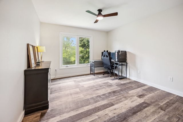 8148 Orchardview Dr, Washington, MI 48095 - home office with a ceiling fan, wood finished floors, and baseboards