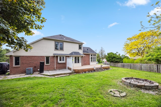 8148 Orchardview Dr, Washington, MI 48095 - rear view of property featuring a fire pit, brick siding, a deck, central AC, and a patio