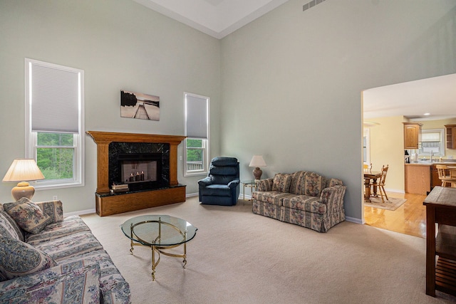 4024 Hosner Rd, Metamora, MI 48455 - living room featuring high vaulted ceiling, plenty of natural light, light carpet, and a fireplace