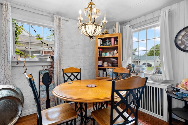 8911 Manor Ave, Allen Park, MI 48101 - dining area featuring healthy amount of natural light, a chandelier, and wood finished floors