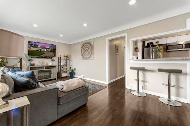 23830 Shakespeare Ave, Eastpointe, MI 48021 - living room with dark wood-style floors, baseboards, recessed lighting, and a glass covered fireplace