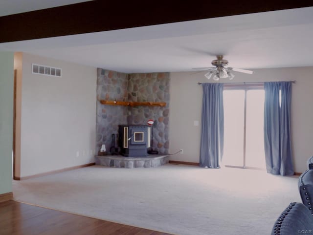 9421 Springville Hwy, Onsted, MI 49265 - living room with a wood stove, a ceiling fan, baseboards, and wood finished floors