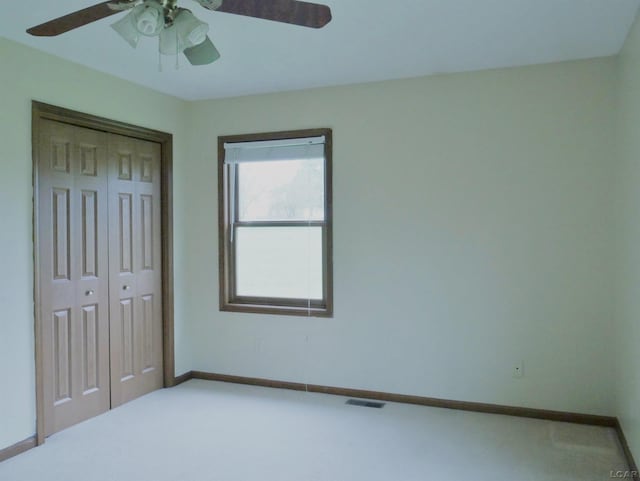 9421 Springville Hwy, Onsted, MI 49265 - unfurnished bedroom featuring a closet, carpet, baseboards, and a ceiling fan