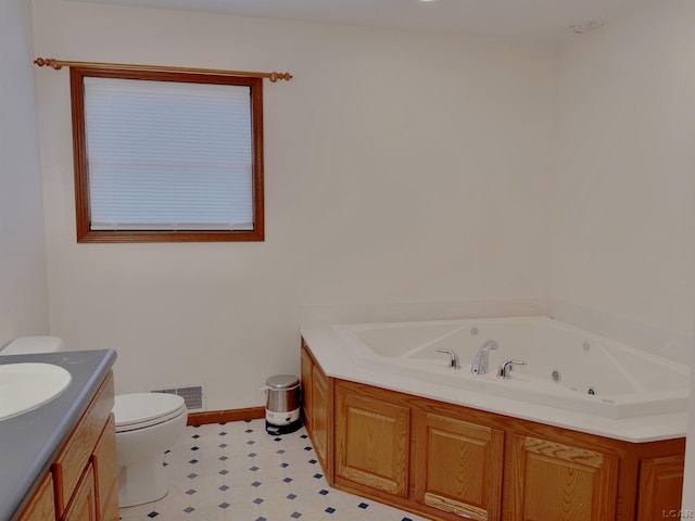 9421 Springville Hwy, Onsted, MI 49265 - full bathroom featuring tile patterned floors, toilet, a whirlpool tub, vanity, and baseboards