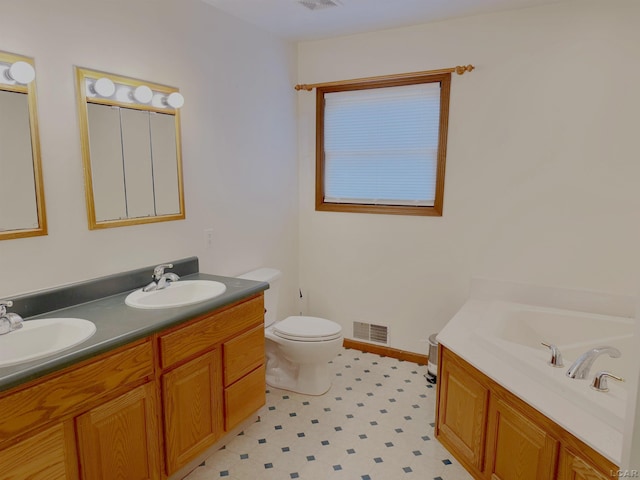 9421 Springville Hwy, Onsted, MI 49265 - bathroom featuring toilet, a bath, double vanity, and tile patterned floors