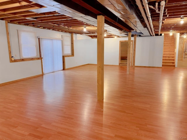 9421 Springville Hwy, Onsted, MI 49265 - finished below grade area featuring light wood-type flooring, stairs, and baseboards