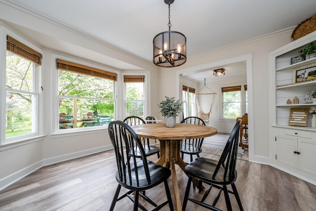 5915 S Pipestone Rd, Eau Claire, MI 49111 - dining space with a chandelier, plenty of natural light, light wood-type flooring, and ornamental molding