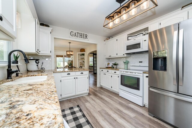 5915 S Pipestone Rd, Eau Claire, MI 49111 - kitchen featuring white appliances, a sink, white cabinetry, and tasteful backsplash