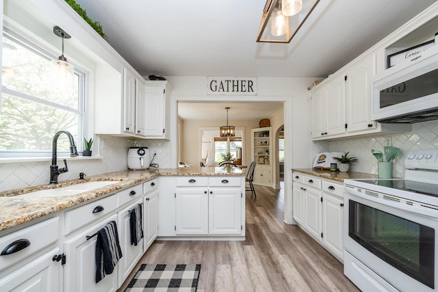 5915 S Pipestone Rd, Eau Claire, MI 49111 - kitchen featuring white appliances, a sink, and tasteful backsplash