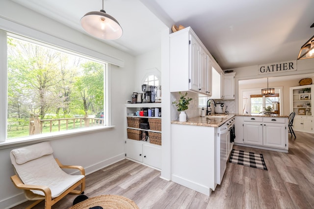 5915 S Pipestone Rd, Eau Claire, MI 49111 - kitchen featuring a sink, white cabinets, light wood-style floors, and light stone countertops