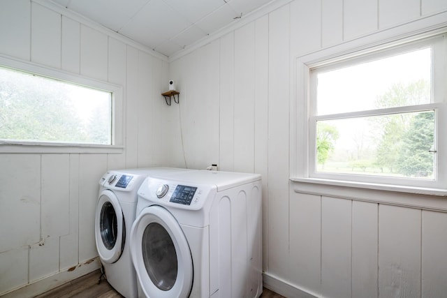 5915 S Pipestone Rd, Eau Claire, MI 49111 - laundry area with washer and dryer, wood finished floors, and a decorative wall