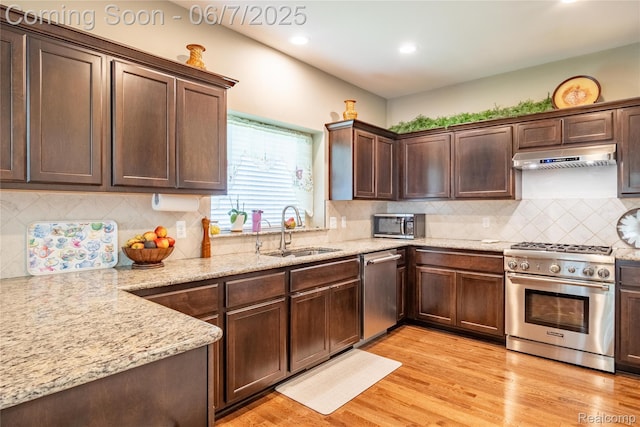 791 Glen Meadows Dr, South Lyon, MI 48178 - kitchen featuring stainless steel appliances, a sink, light wood-type flooring, dark brown cabinetry, and light stone counters