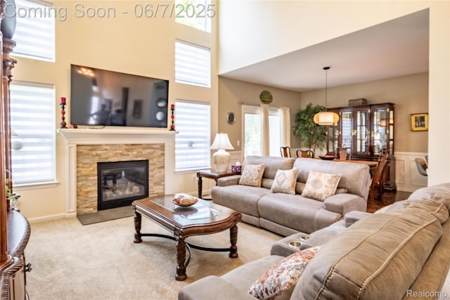 791 Glen Meadows Dr, South Lyon, MI 48178 - carpeted living area with plenty of natural light, a high ceiling, and a fireplace
