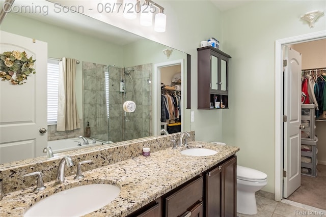 791 Glen Meadows Dr, South Lyon, MI 48178 - full bathroom with a spacious closet, double vanity, a stall shower, toilet, and tile patterned flooring