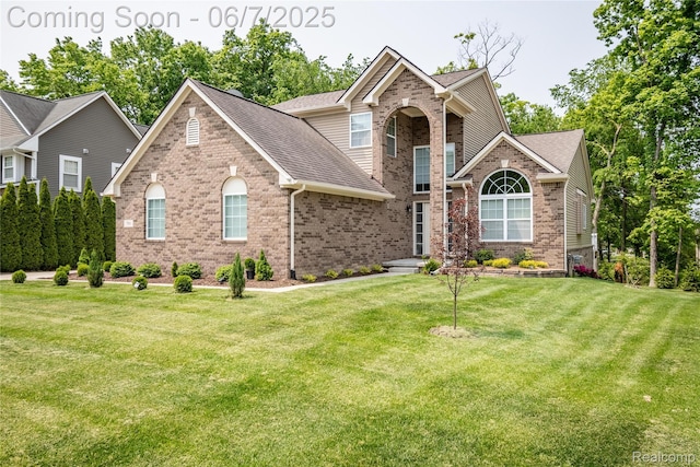 791 Glen Meadows Dr, South Lyon, MI 48178 - traditional-style house featuring brick siding, a front yard, and roof with shingles
