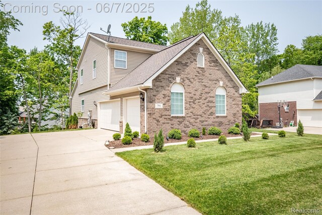 791 Glen Meadows Dr, South Lyon, MI 48178 - view of front of property with brick siding, concrete driveway, a front yard, an attached garage, and a shingled roof