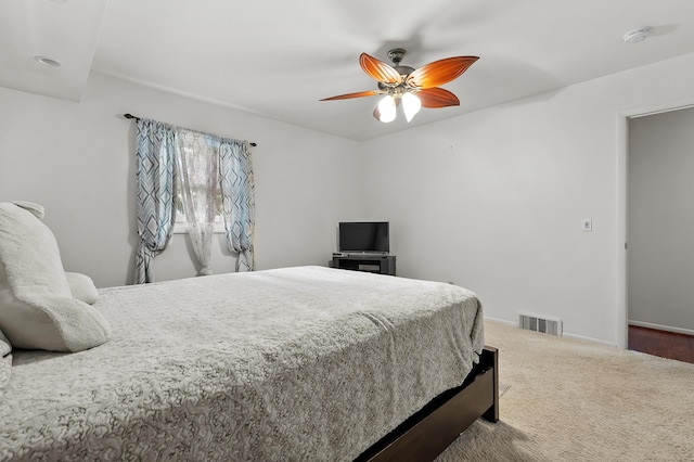 carpeted bedroom featuring ceiling fan and baseboards