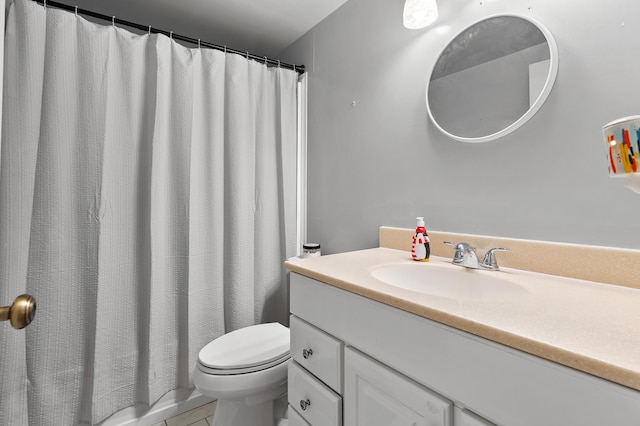 bathroom with toilet, vanity, and curtained shower