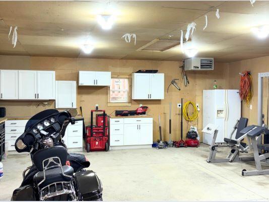 garage featuring white refrigerator with ice dispenser