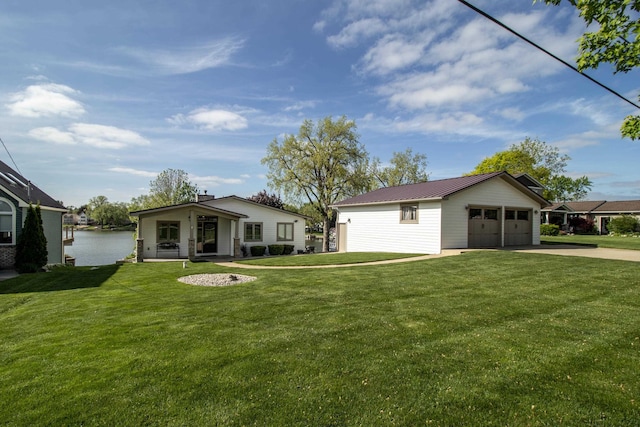 13496 S Horrell Rd, Fenton, MI 48430 - view of front facade featuring a garage, a front yard, metal roof, and driveway