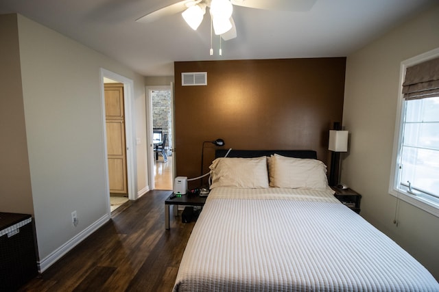 13496 S Horrell Rd, Fenton, MI 48430 - bedroom featuring dark wood-style flooring, baseboards, and a ceiling fan