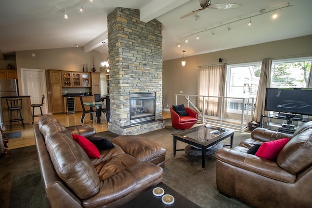 13496 S Horrell Rd, Fenton, MI 48430 - living area featuring ceiling fan, beverage cooler, rail lighting, and a stone fireplace