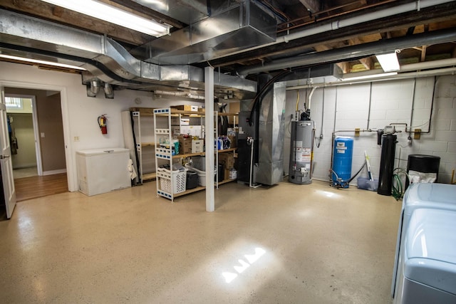 13496 S Horrell Rd, Fenton, MI 48430 - unfinished below grade area featuring water heater, washer and dryer, heating unit, refrigerator, and concrete block wall