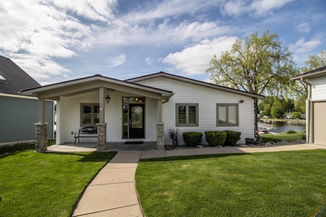 13496 S Horrell Rd, Fenton, MI 48430 - view of front of home featuring a front lawn, covered porch, and a water view