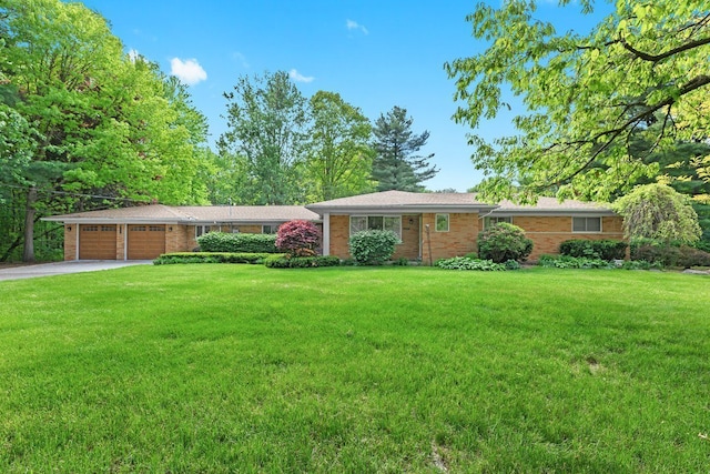 52851 Fairchild Rd, Chesterfield, MI 48051 - ranch-style home with an attached garage, driveway, a front lawn, and brick siding