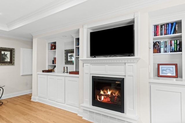52851 Fairchild Rd, Chesterfield, MI 48051 - living room with light wood-type flooring, ornamental molding, a warm lit fireplace, built in shelves, and baseboards