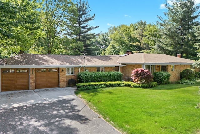 52851 Fairchild Rd, Chesterfield, MI 48051 - ranch-style house featuring a garage, brick siding, a front lawn, concrete driveway, and a chimney