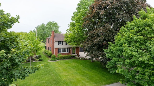 2366 Grange Rd, Trenton, MI 48183 - view of front of home featuring brick siding, a front lawn, and a chimney