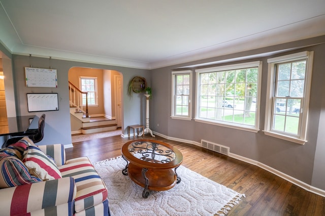2366 Grange Rd, Trenton, MI 48183 - living area featuring arched walkways, wood finished floors, stairs, baseboards, and ornamental molding