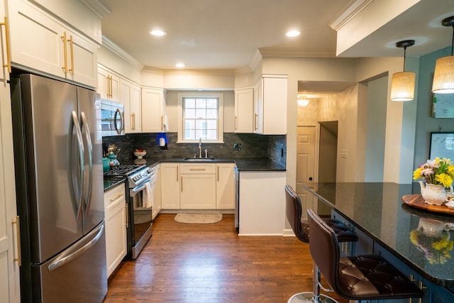 2366 Grange Rd, Trenton, MI 48183 - kitchen featuring appliances with stainless steel finishes, a sink, crown molding, dark wood-style flooring, and decorative backsplash