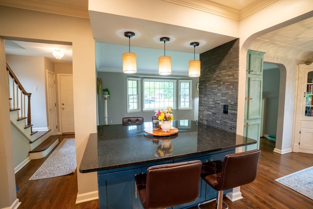 2366 Grange Rd, Trenton, MI 48183 - kitchen featuring dark wood-style floors, arched walkways, pendant lighting, and crown molding