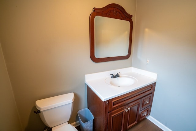 2366 Grange Rd, Trenton, MI 48183 - bathroom with toilet, vanity, baseboards, and wood finished floors