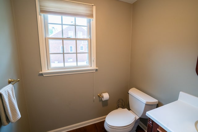 2366 Grange Rd, Trenton, MI 48183 - half bathroom featuring vanity, toilet, baseboards, and wood finished floors