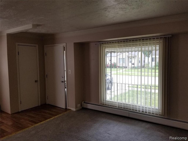 7267 William St, Taylor, MI 48180 - carpeted foyer entrance featuring a baseboard heating unit and a textured ceiling