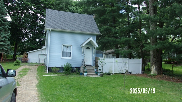 823 21st St, Jackson, MI 49203 - view of front facade with entry steps, driveway, and a shingled roof
