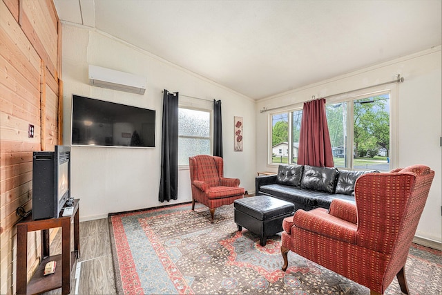 living area with vaulted ceiling, a wall mounted AC, wood walls, crown molding, and wood finished floors