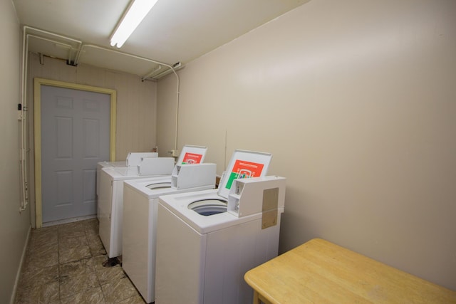 shared laundry room featuring independent washer and dryer and attic access
